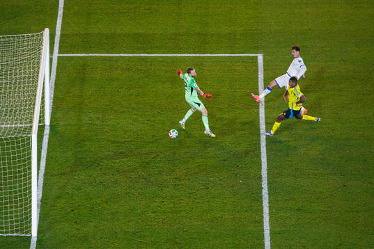 Fisnik Asllani of Kosovo scores 0-1 behind goalkeeper