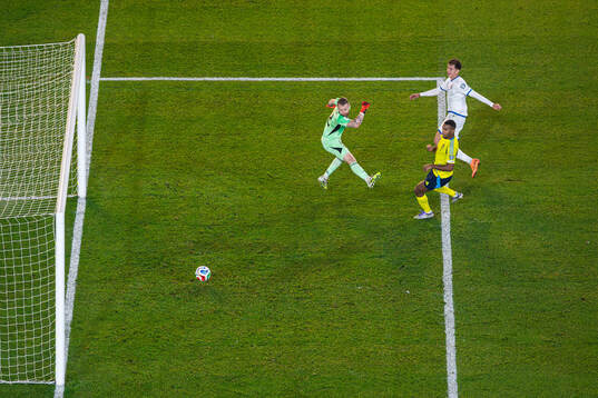 Fisnik Asllani of Kosovo scores 0-1 behind goalkeeper