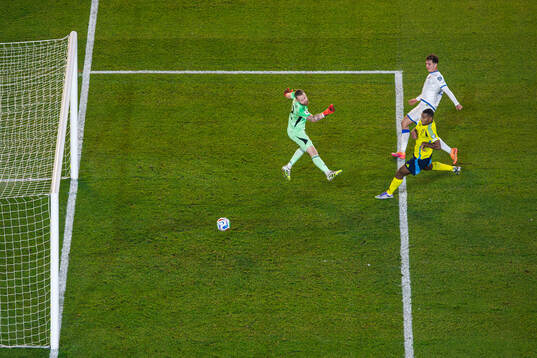 Fisnik Asllani of Kosovo scores 0-1 behind goalkeeper