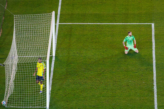 Isak Hien and goalkeeper Viktor Johansson of Sweden look