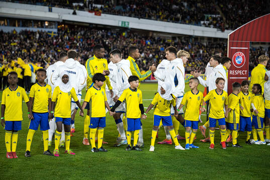 Mascots in front of players of Sweden and Kosovo