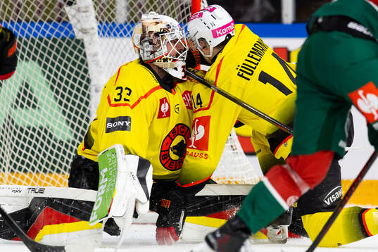 Goaltender Sandro Zurkirchen and Louis Fullemann of SC Bern