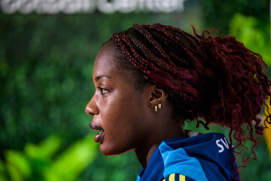 Evelyn Ijeh is interviewed by the media at a press event