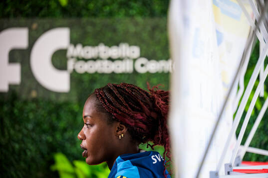 Evelyn Ijeh is interviewed by the media at a press event