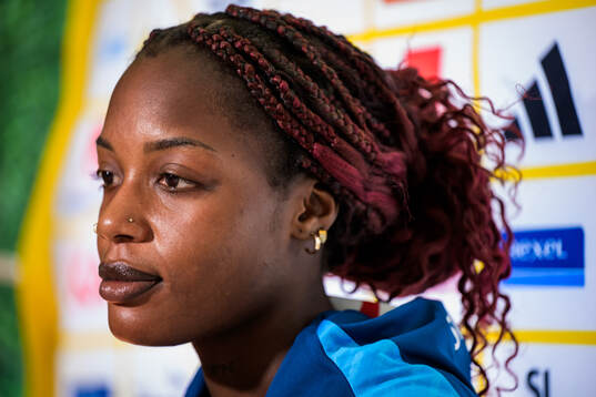 Evelyn Ijeh is interviewed by the media at a press event