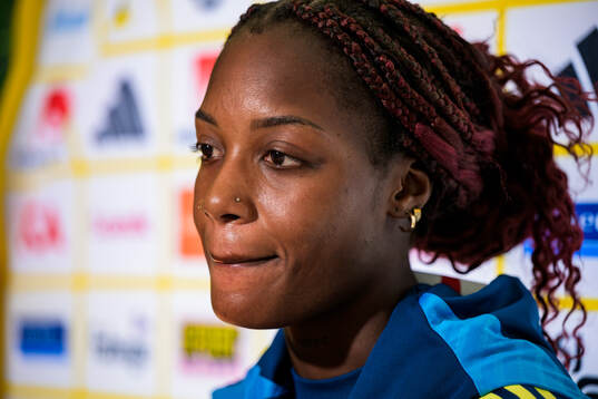 Evelyn Ijeh is interviewed by the media at a press event