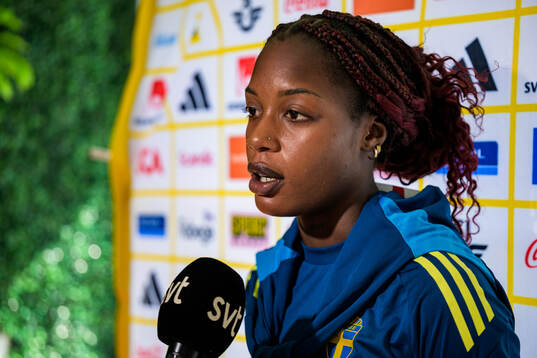 Evelyn Ijeh is interviewed by the media at a press event
