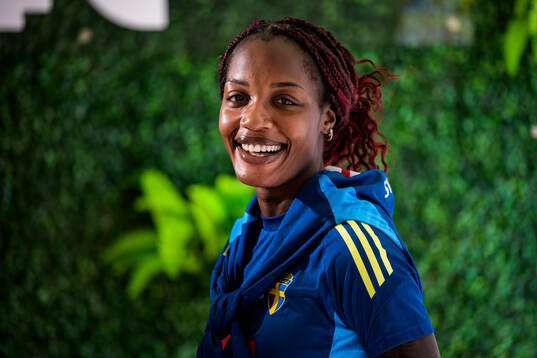 Evelyn Ijeh is interviewed by the media at a press event