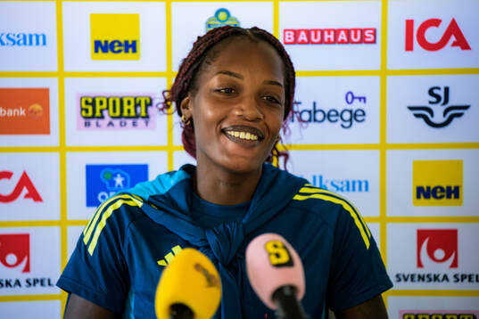 Evelyn Ijeh is interviewed by the media at a press event