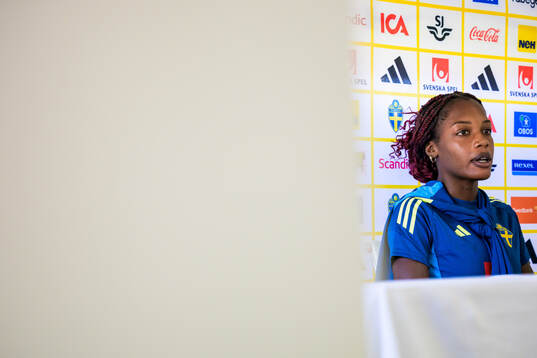 Evelyn Ijeh is interviewed by the media at a press event