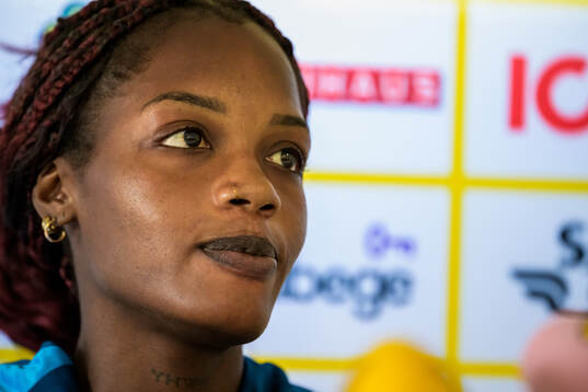 Evelyn Ijeh is interviewed by the media at a press event