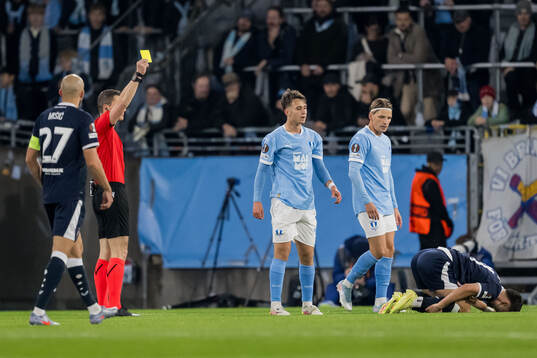 Kenan Busuladzic of Malmö FF receives a yellow card