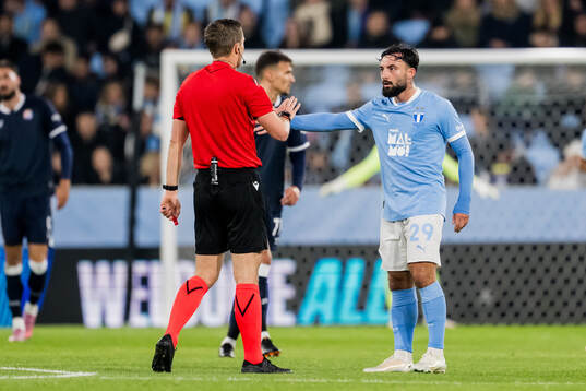Sead Haksabanovic of Malmö FF and Referee Willy Delajod