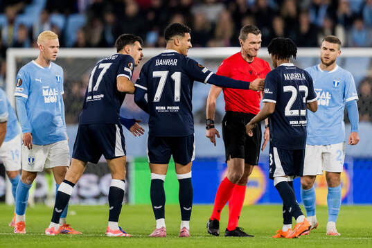 Referee Willy Delajod and Cardoso Varela of Dinamo Zagreb