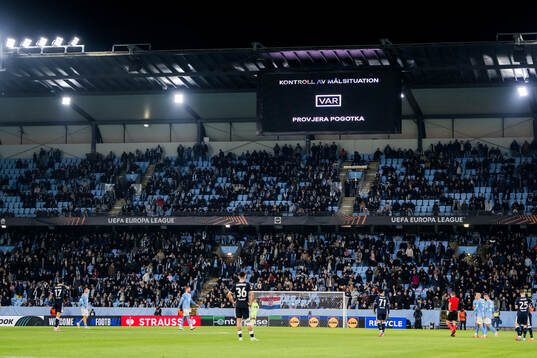 The big screen displays a VAR review message