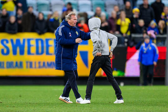 Security manager Lars From stops a pitch invader