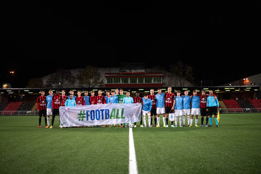 The players and the referees pose for a picture