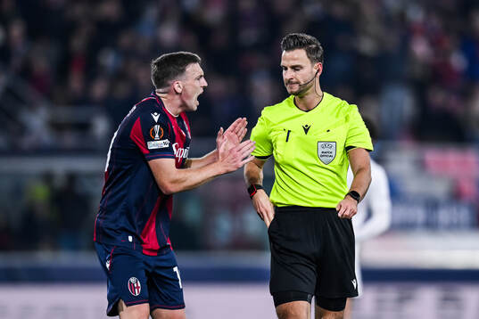Lewis Ferguson of Bologna and referee Daniel Schlager