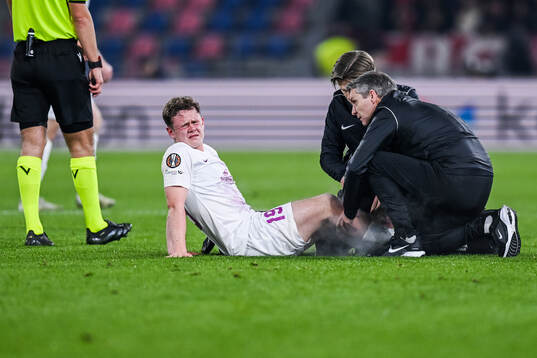 Eggert Aron Gudmundsson of Brann receives medical attention