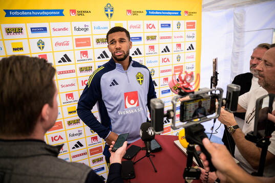 Isak Hien of the Swedish national football team talking to