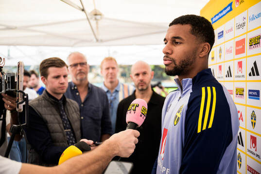Isak Hien of the Swedish national football team talking to