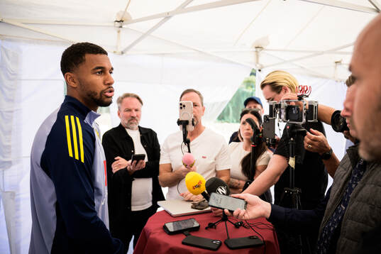 Isak Hien of the Swedish national football team talking to