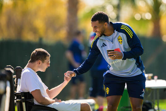 Isak Hien of the Swedish national football team greets a