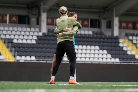 Goalkeeper Jennifer Falk and Tabby Tindell celebrates