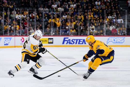 Erik Karlsson of Pittsburgh Penguins and Michael Bunting of