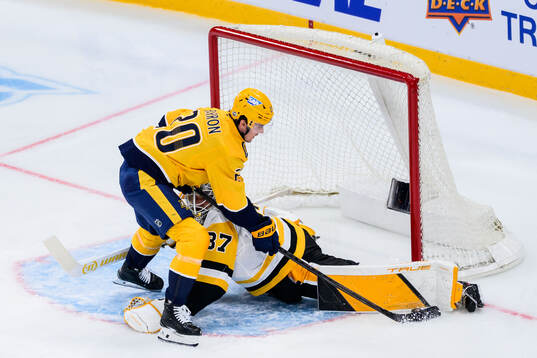 Justin Barron of Nashville Predators and goalkeeper Arturs