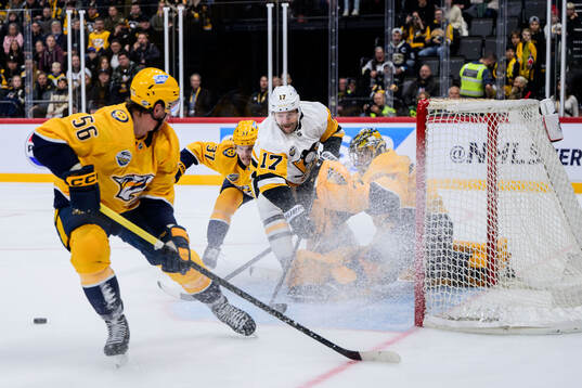 Bryan Rust of Pittsburgh Penguins against Erik Haula, Nick