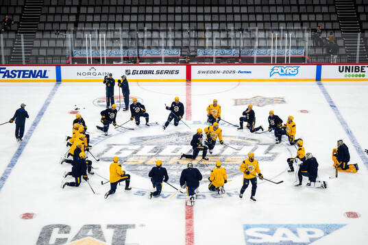 The players gather around Filip Forsberg at a practice