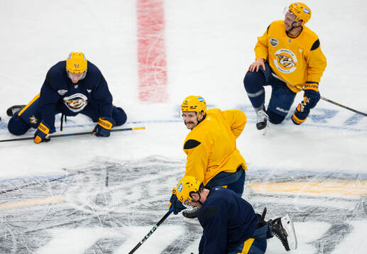 The players gather around Filip Forsberg at a practice