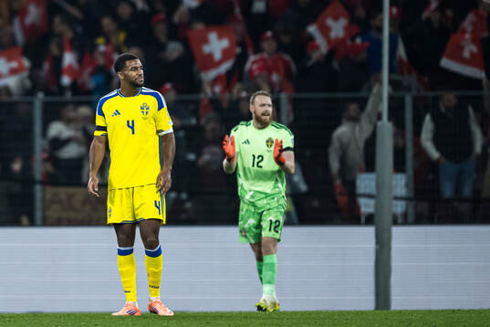 Isak Hien and goalkeeper Viktor Johansson of Switzerland