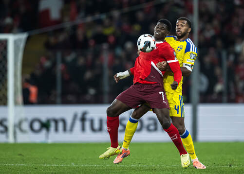 Breel Embolo of Switzerland and Isak Hien of Sweden