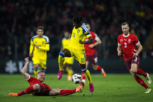 Nico Elvedi of Switzerland and Anthony Elanga of Sweden