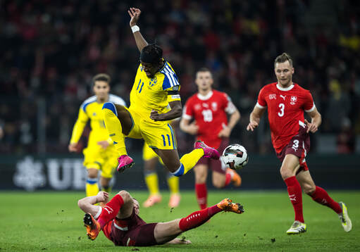 Nico Elvedi of Switzerland and Anthony Elanga of Sweden