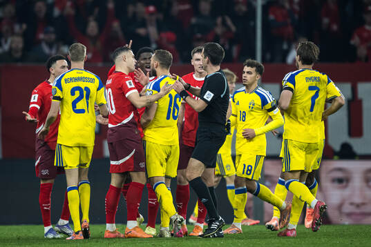 Jesper Karlström of Sweden receives a yellow card