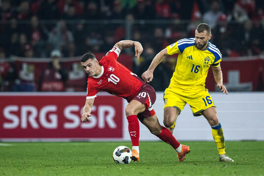 Granit Xhaka of Switzerland and Jesper Karlström of Sweden