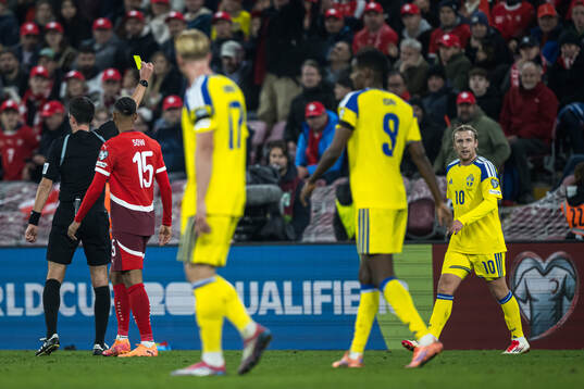 Emil Forsberg of Sweden receives a yellow card