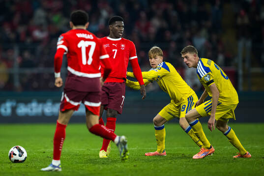Ruben Vargas and Breel Embolo of Switzerland are being