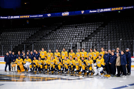 Players and staff of Nashville Predators pose for a team