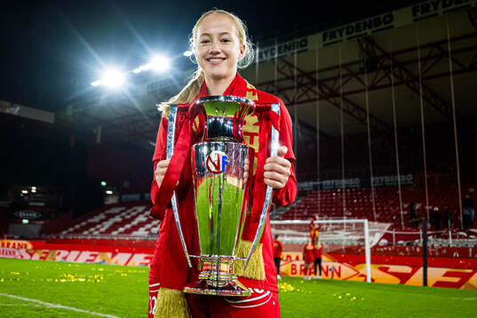 Maren Johnsen of Brann celebrates with the trophy