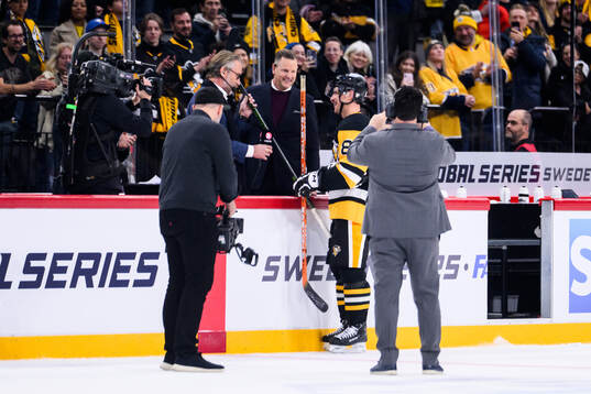 Sidney Crosby of Pittsburgh Penguins receives a hockey
