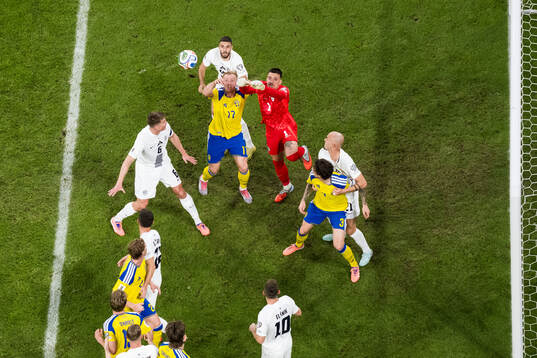 Isac Lidberg of Sweden and goalkeeper Igor Vekic of Slovenia