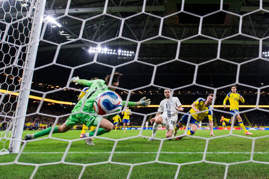 Timi Elsnik of Slovenia scores the 0-1 goal behind
