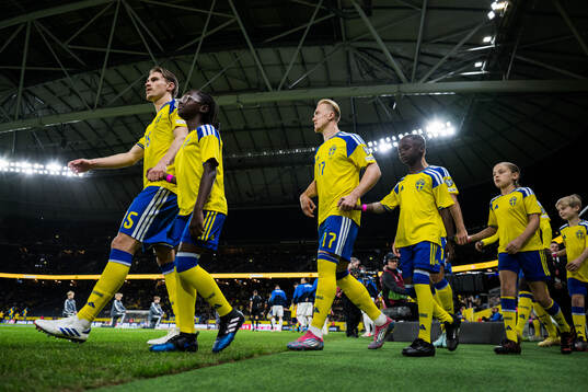 Carl Starfelt and Isac Lidberg of Sweden enter the pitch