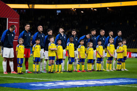 Players of Slovenia in front of mascots