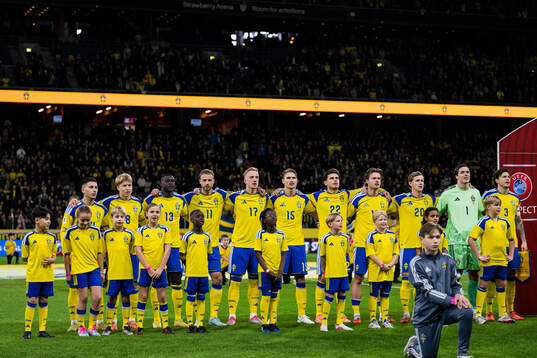 Players of Sweden in front of mascots
