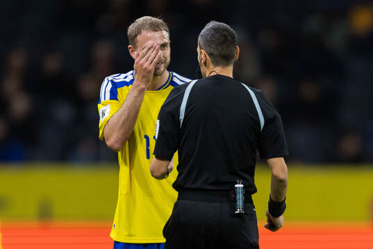 Gustav Lundgren of Sweden and referee Maurizio Mariani
